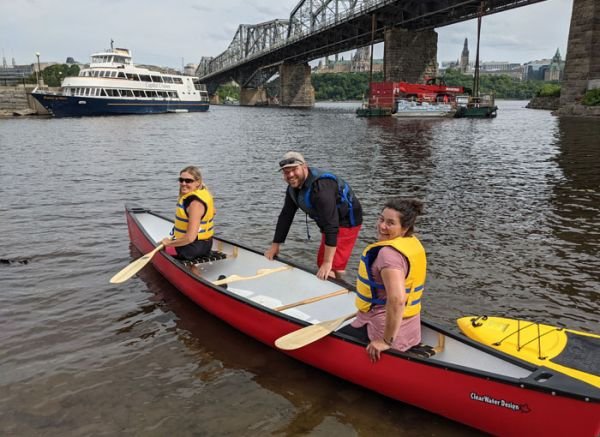 Two friends canoe the Ottawa river wearing lifejackets