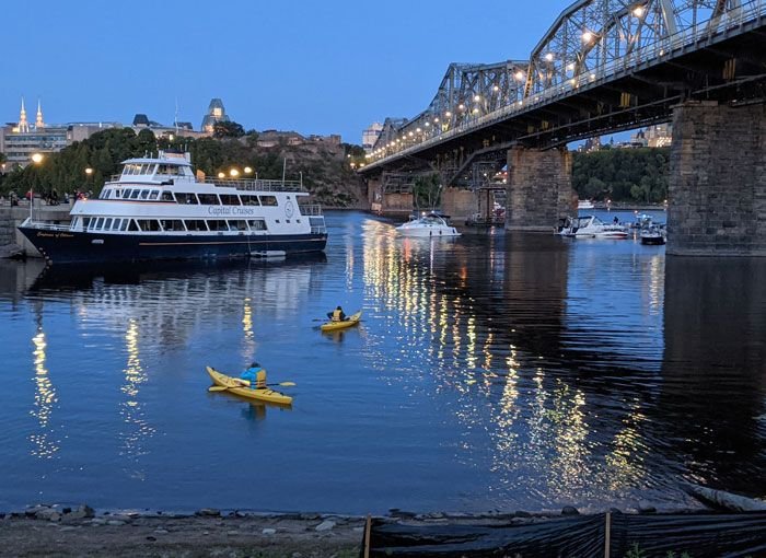 Kayakers returning to shore after Escape sunset Kayak tour of the Ottawa River